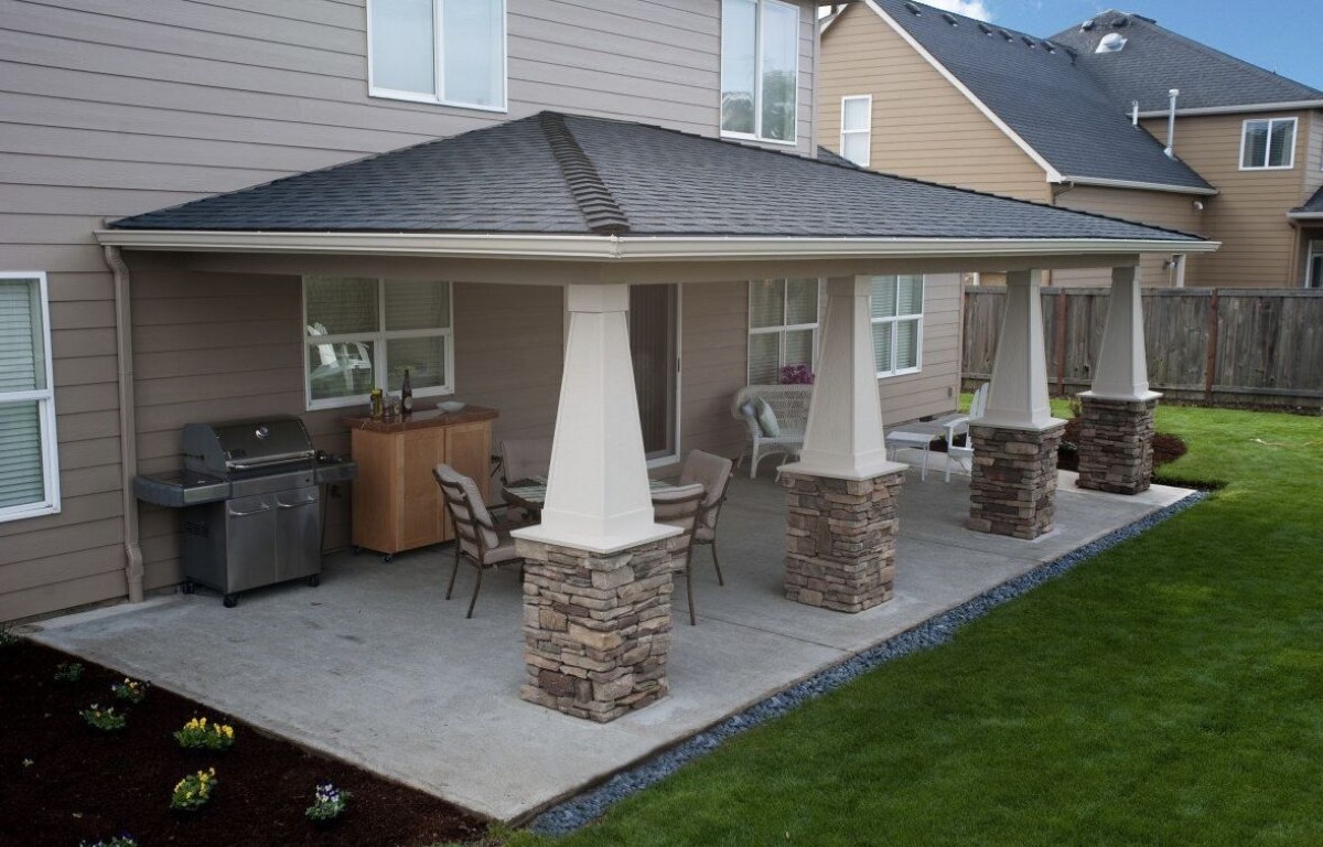 Beautiful covered concrete patio with stone column bases installed in Laredo, TX